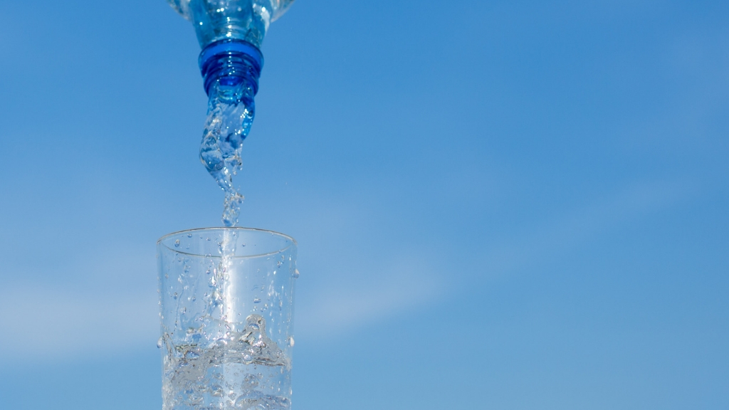 a glass of water being poured into a glass