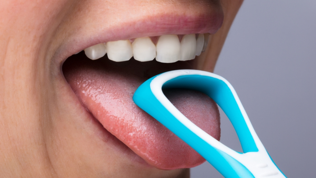 a person's mouth with a blue and white tube