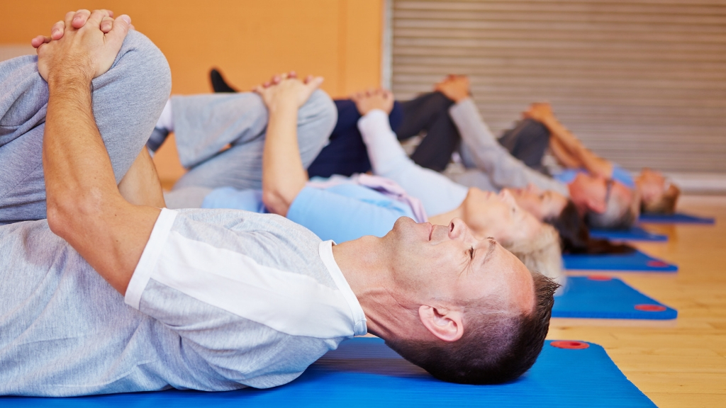 students stretching in a yoga class