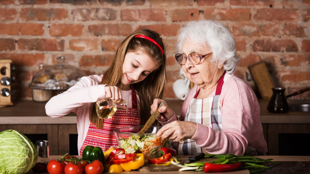 a woman and a girl preparing food