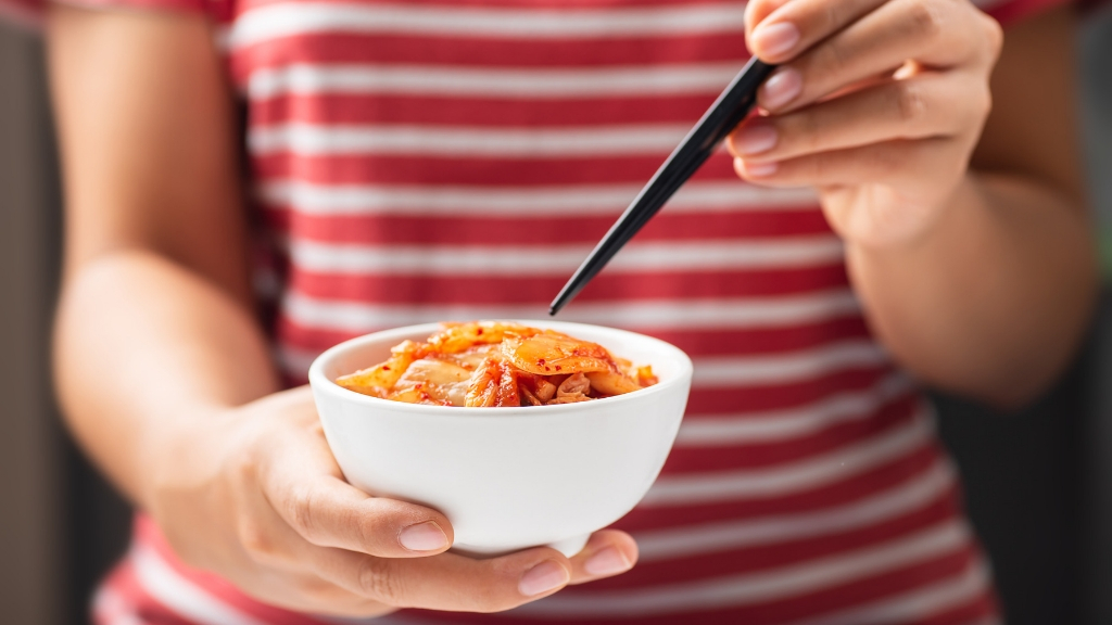 a woman cutting a bowl of food