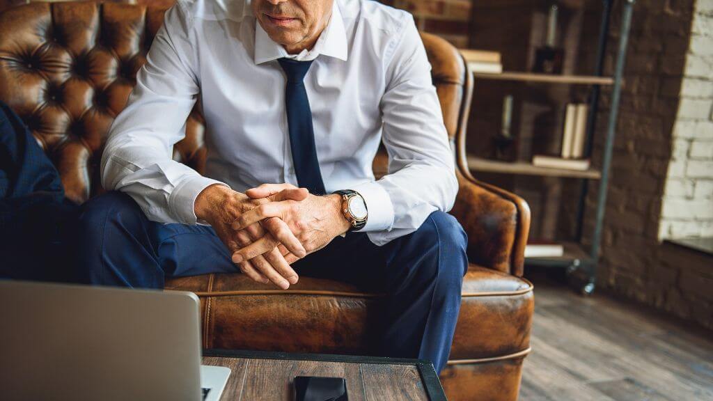 A businessman looking at his laptop's screen