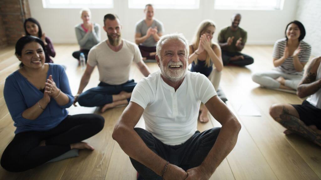 An eclectic group of people in a yoga class