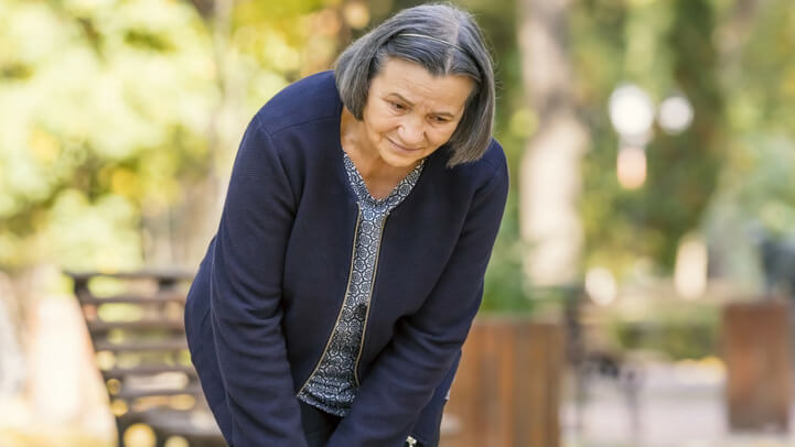 Older woman in pain, holding her knee