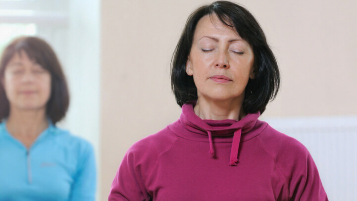 A middle aged woman meditating