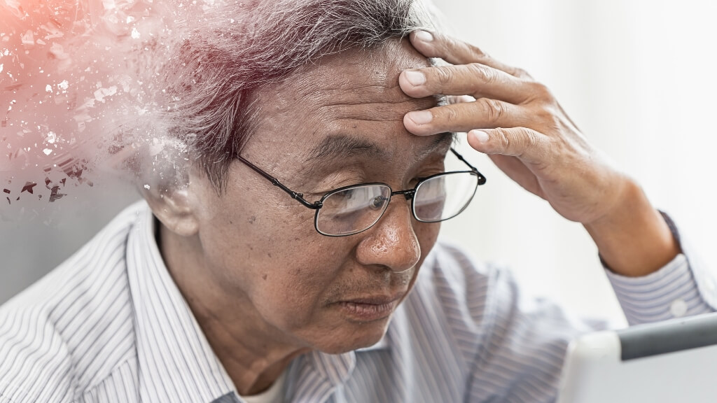A focused man with part of his head cloudy, suggesting he is forgetful.