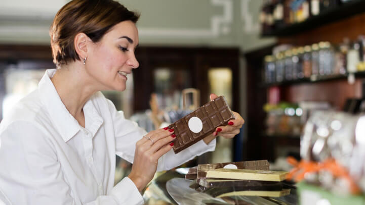 Woman choosing chocolate at the store