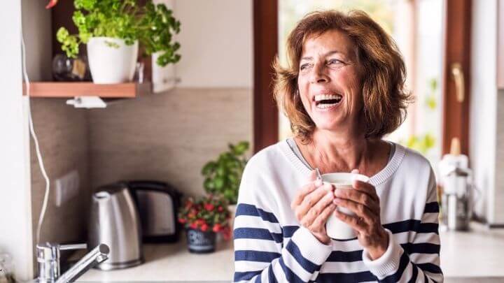 Laughing older woman in the kitchen