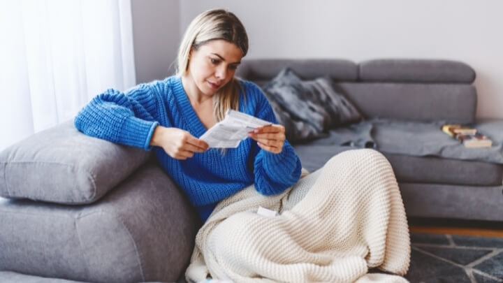 Woman reading a leaflet about side effects