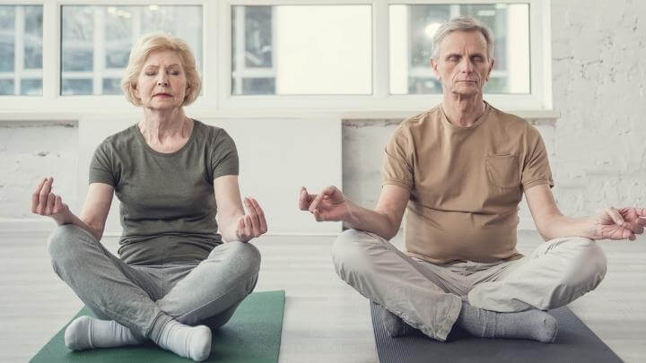 Elderly couple meditating together