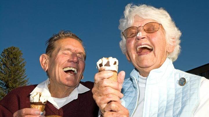 Senior couple having ice cream and sharing a laugh