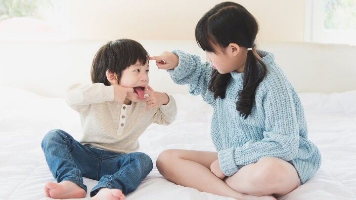 A big sister playing with her brother