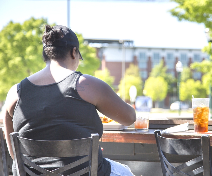 Obese woman eating fries