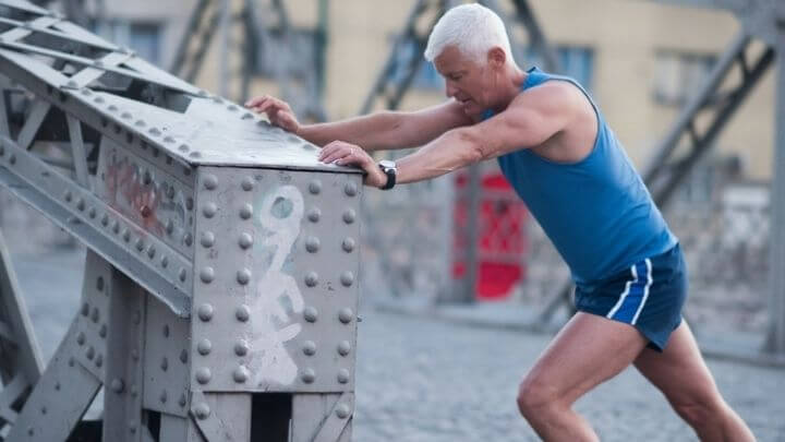 Older man stretching before jogging