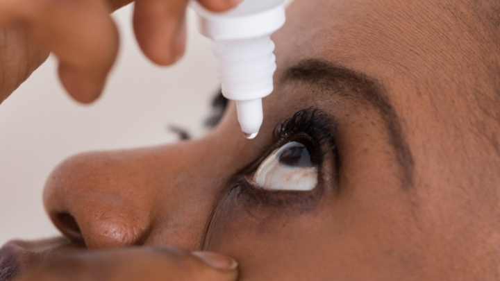 Woman putting a drop in her eye