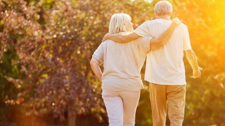 A senior couple taking a walk at sunset