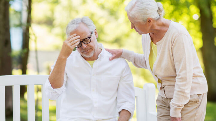 A woman helping her husband who is confused