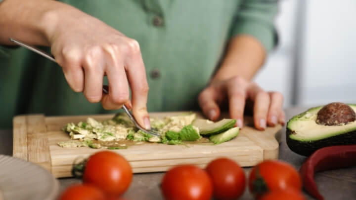 Woman preparing avocado toast