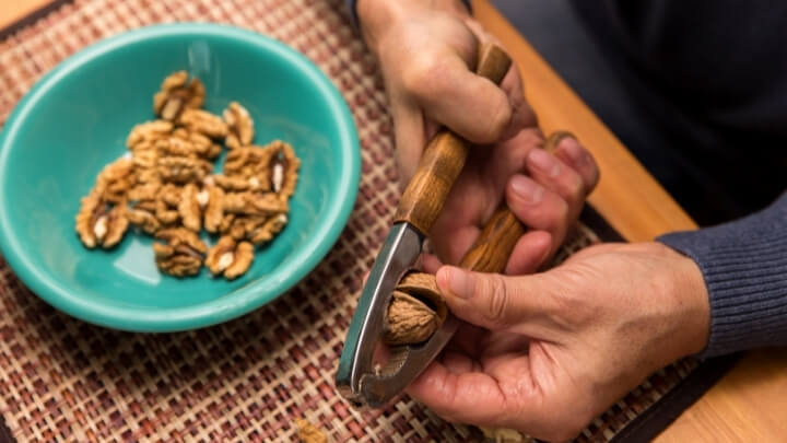 Man cracking walnuts open