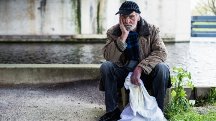 Old thoughtful homeless man