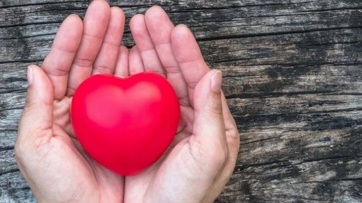 A heart-shaped rubber in man's hands