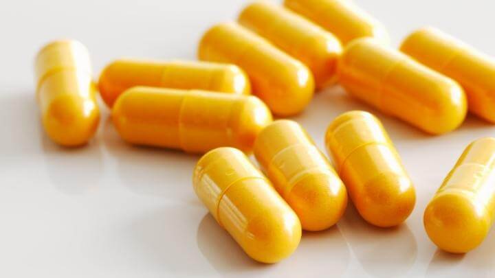 Curcumin capsules on white