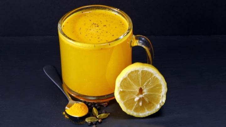 Turmeric golden tea with lemon, pepper and cardamom seeds