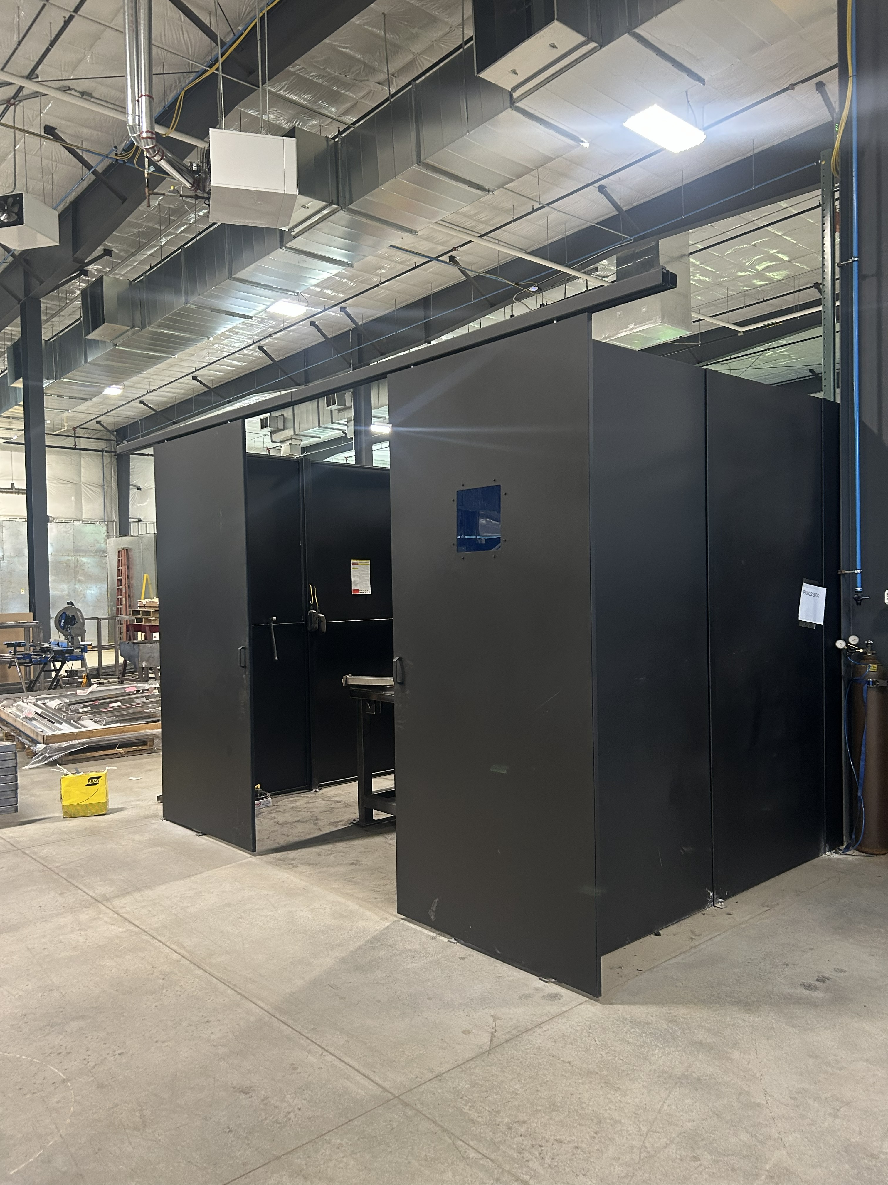 Laser welding enclosure with dual sliding doors