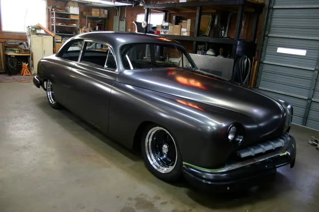 Before: Matte black classic in a garage