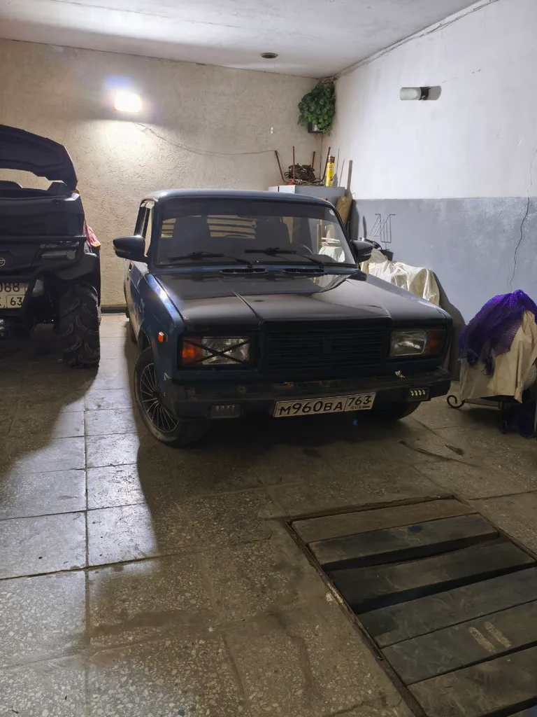 Before: Old sedan in a garage
