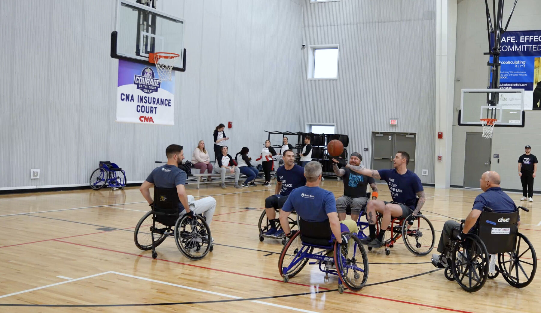 A team of Bank Iowa members playing wheelchair basketball.