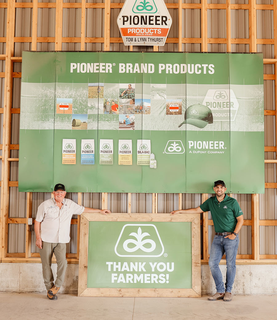 Better Field Solutions Inc. | Tom Brad Standing With Pioneer Signs