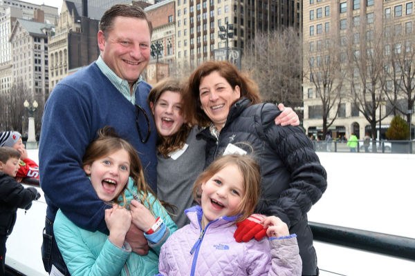 Drake alumni Tom Fitzgerald and his family at an ice skating rink