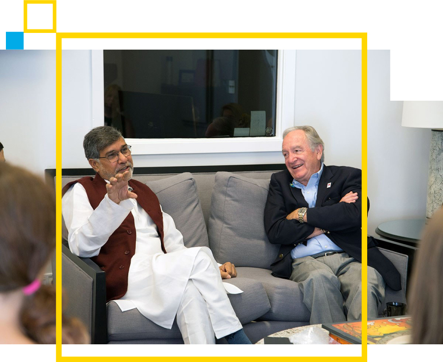 Senator Tom Harkin sitting on a couch with a guest at the Harkin Center