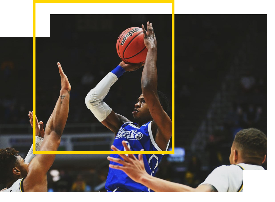 Drake male basketball player jumping shooting the ball in a blue uniform