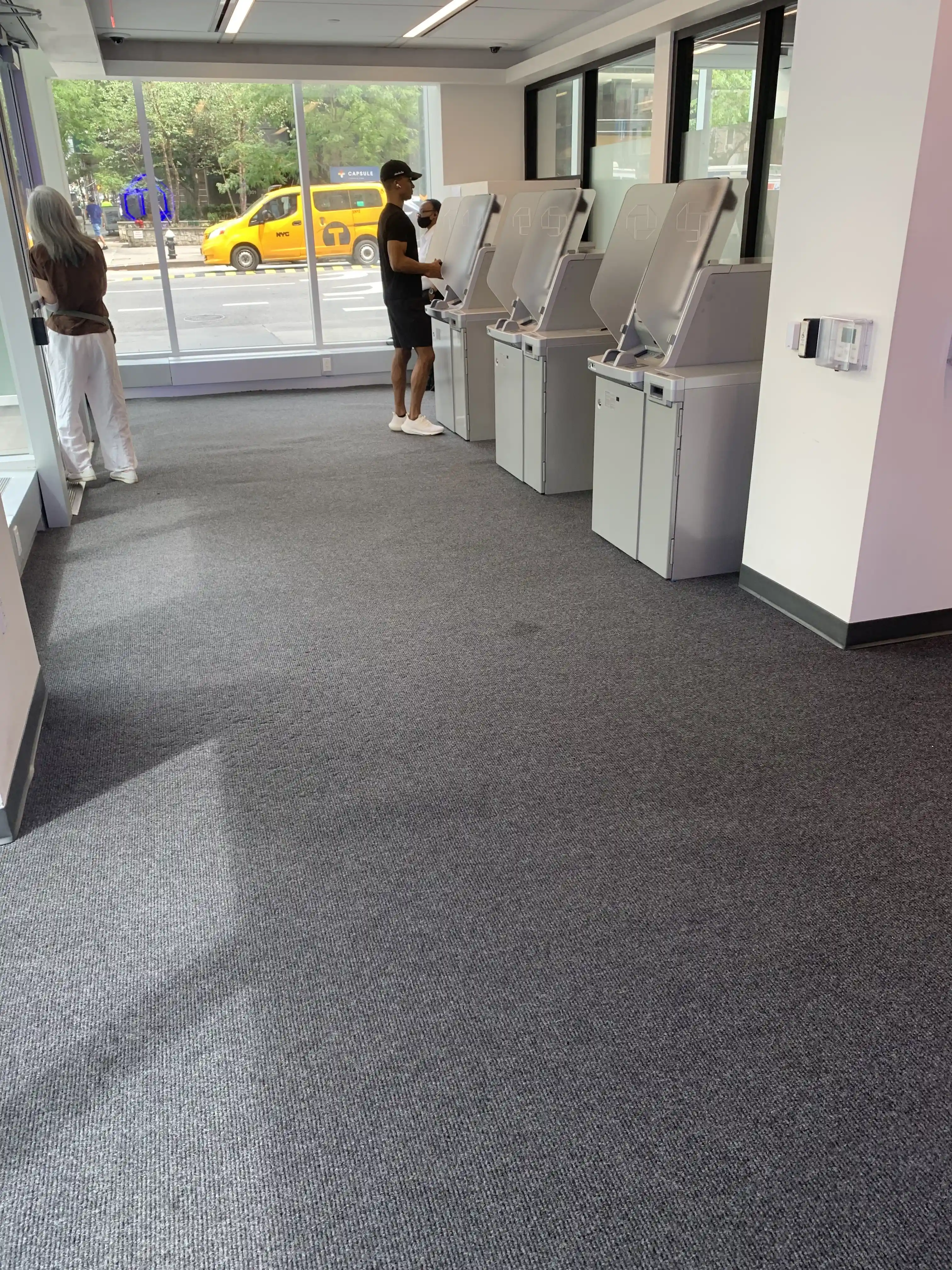 Matting by Design custom grey entrance mat installed in a bank lobby with ATM machines.