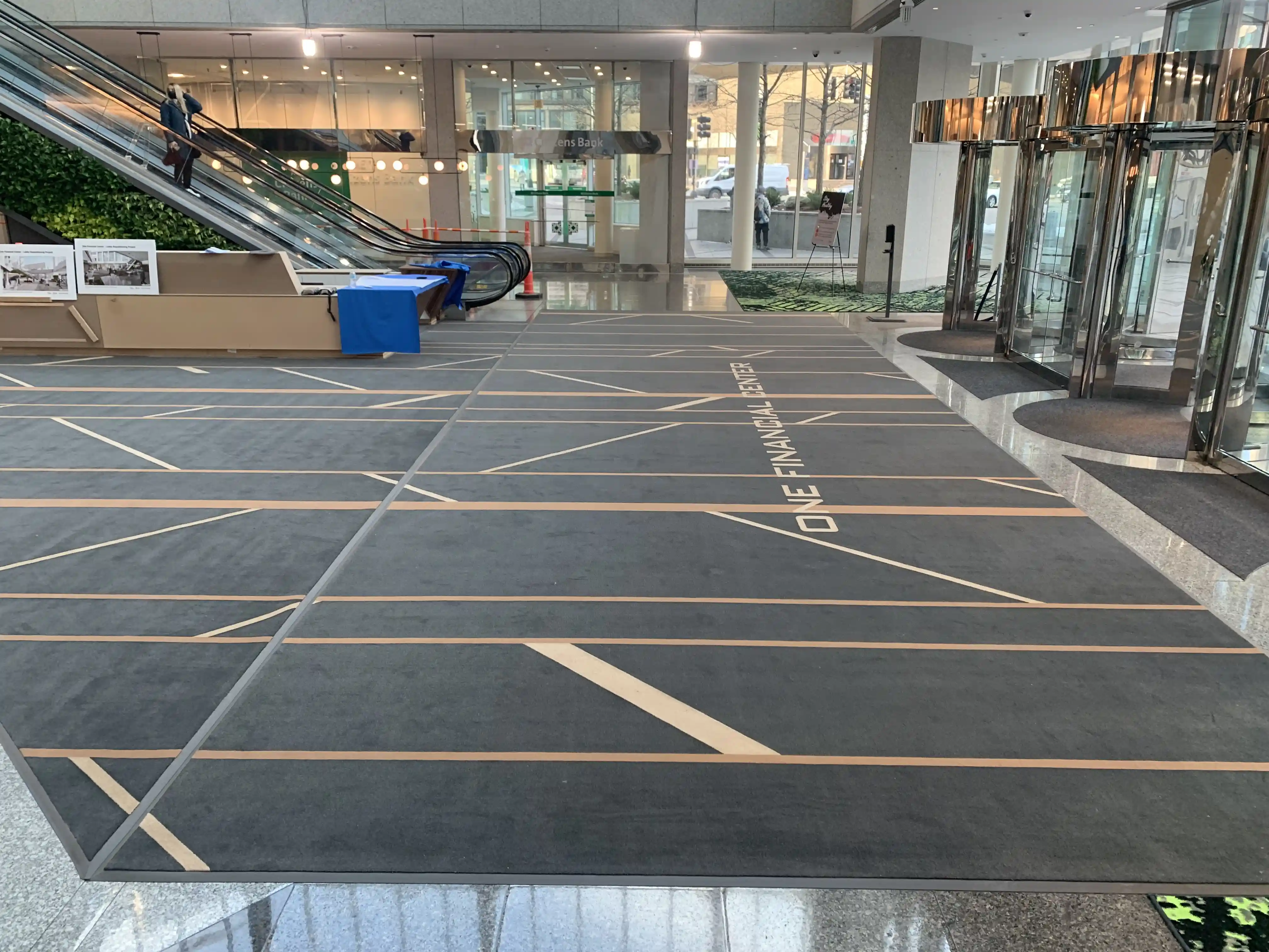 Matting by Design custom logo entrance mat for One Financial Center in a building lobby.