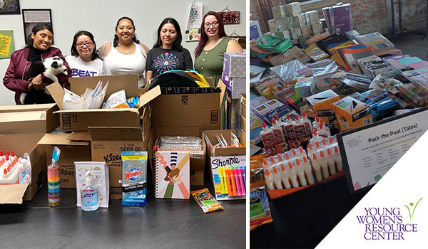 Five women from the Young Women's Resource Center standing together behind boxes filled with school supplies and Two Rivers Marketing donations.