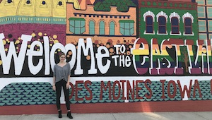 Intern Emi standing in front of mural in east village