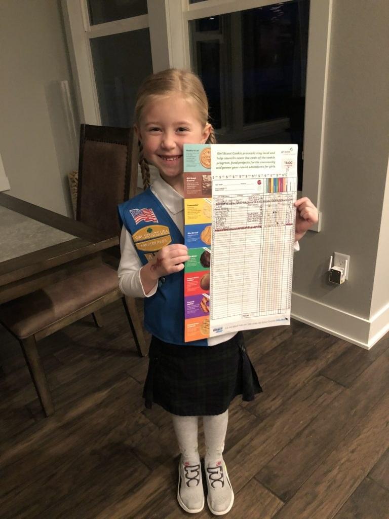 girl scout with cookie order sheet