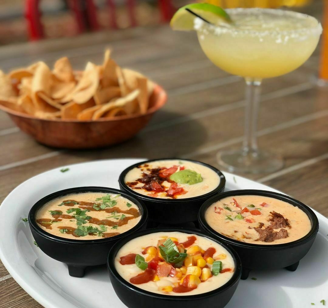 Image of a queso flight with a margarita at Rita's Cantina