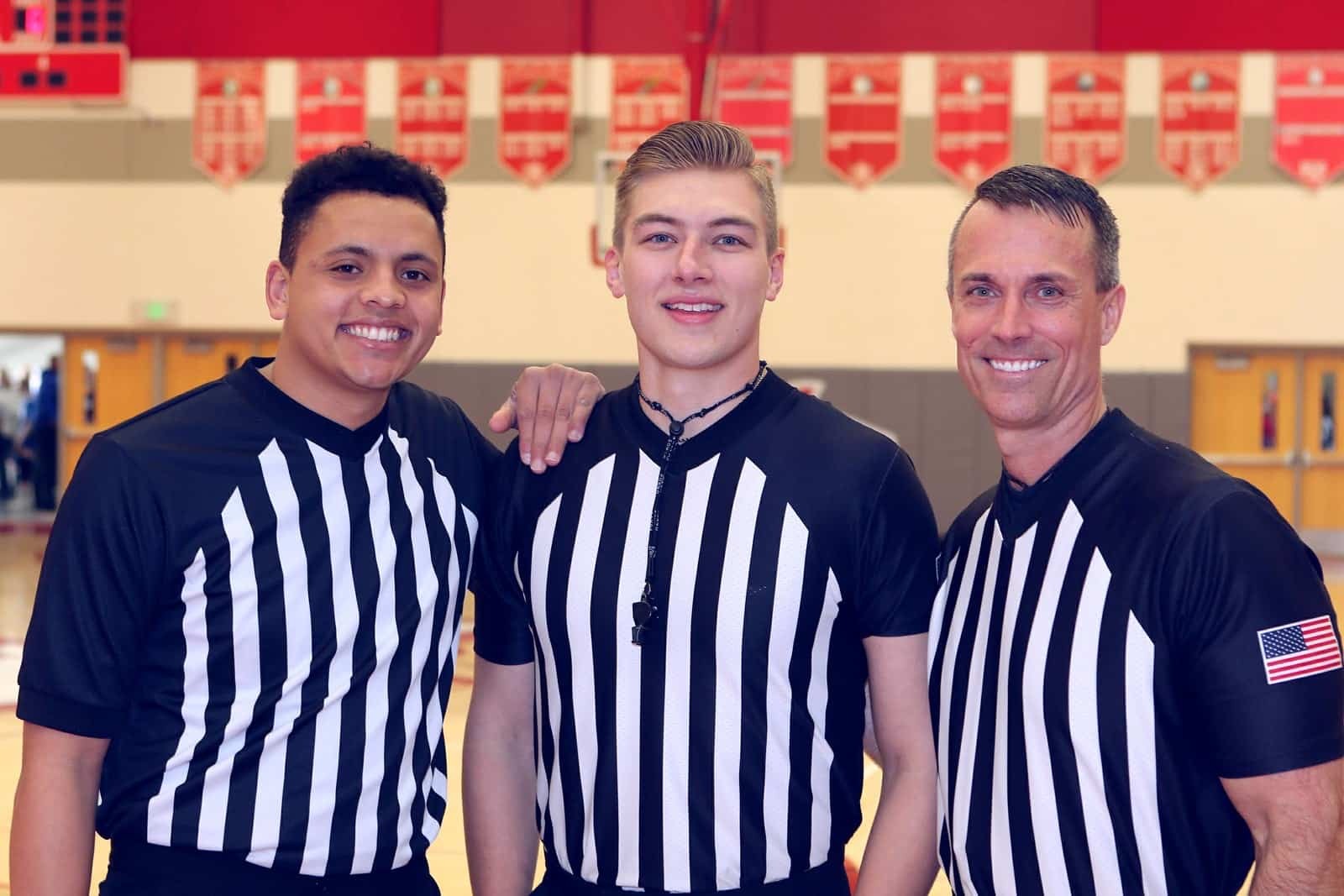 From left to right: Ben Miles in referee uniform with two other referees.