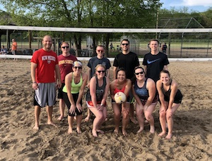Sand volleyball team photo in front of the net