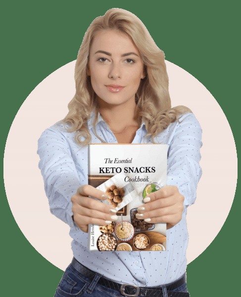 A woman with long blonde hair, wearing a light blue button-up shirt, is holding out a book titled The Essential Keto Snacks Cookbook. The book cover features images of various keto-friendly snacks, such as nuts and low-carb dishes. The background is a soft pink circle, creating a clean and focused presentation