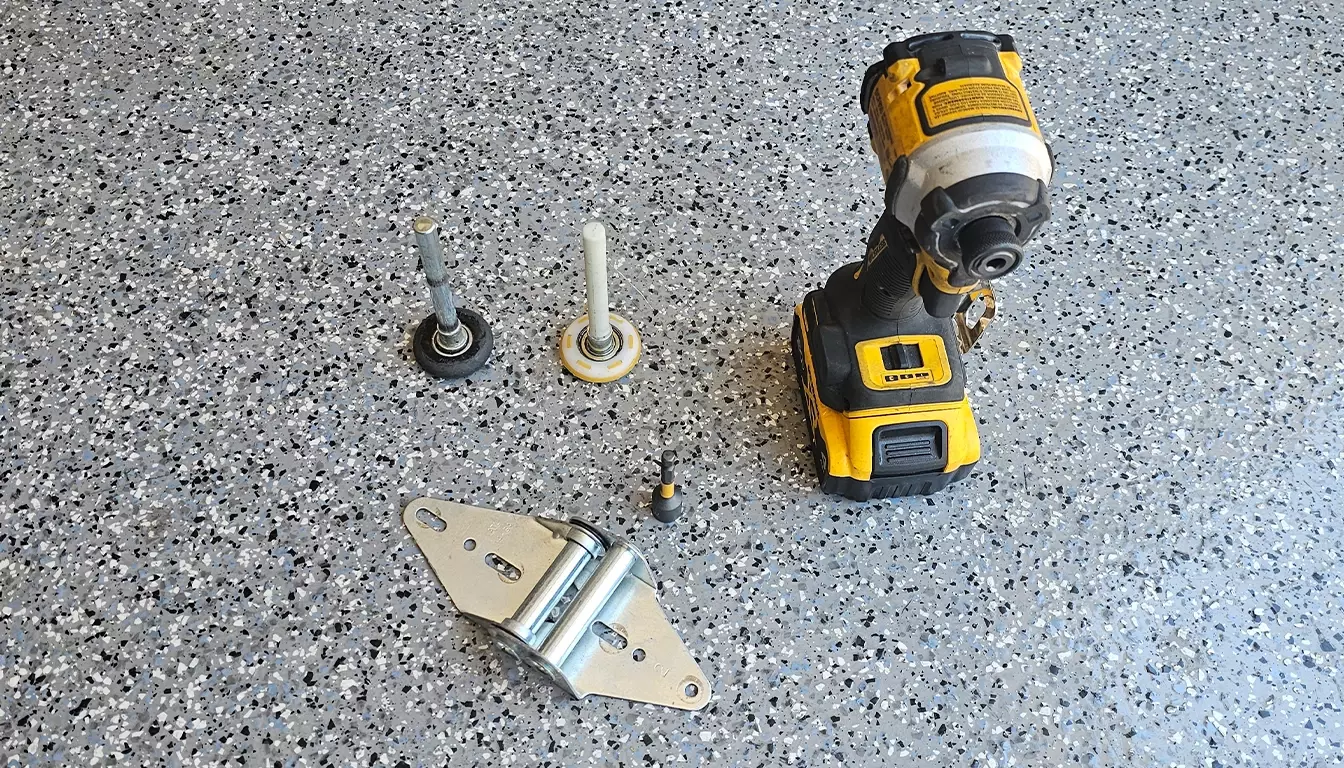 Tools for garage door roller repair Las Vegas including wrench and replacement rollers