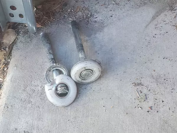 Damaged roller shown during garage door roller repair in Las Vegas