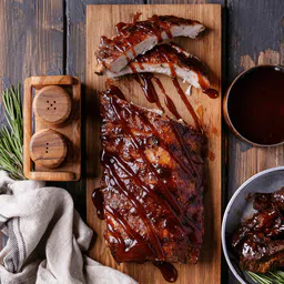 Private label amerpharma premium no added sugar sauces flavour bbq serving suggestion with meat topped with sauce