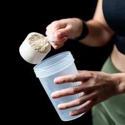 Private label amerpharma vitargo powder pouring powder into a shaker