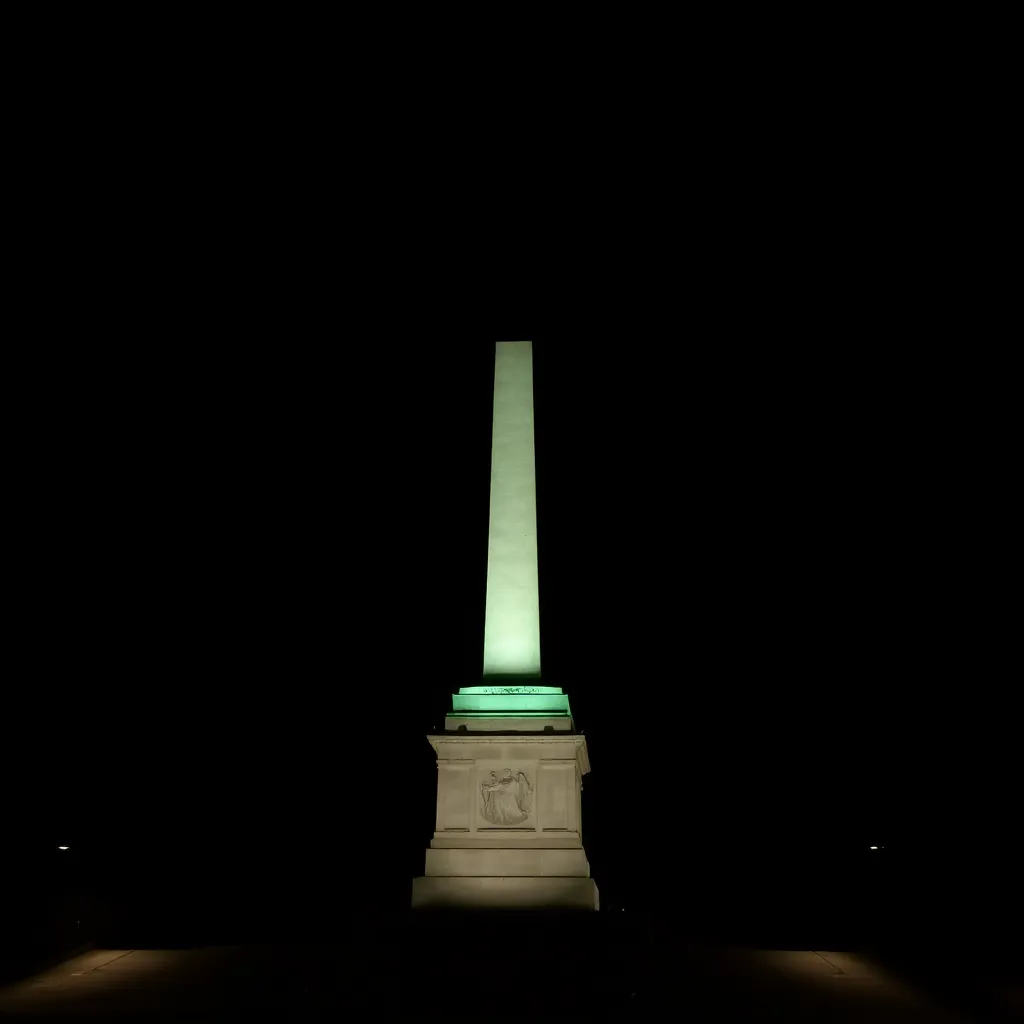 Statue illuminated at night with dark sky background