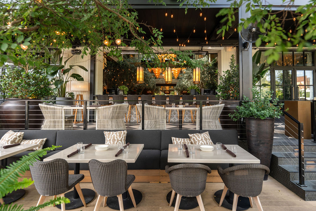 the patio at Aba with tables and greenery